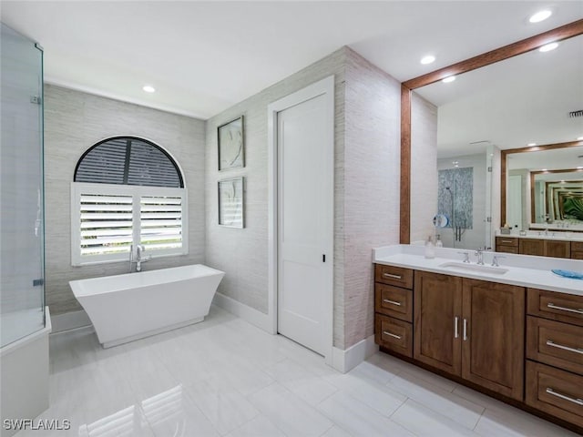 full bath with recessed lighting, visible vents, a freestanding bath, and vanity