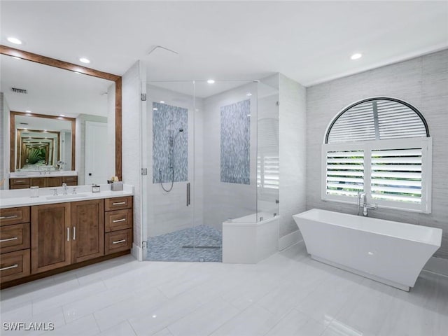 full bath featuring recessed lighting, visible vents, a freestanding bath, a stall shower, and vanity