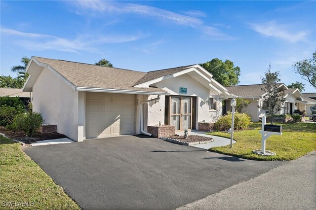 single story home featuring aphalt driveway, stucco siding, a shingled roof, a front yard, and a garage