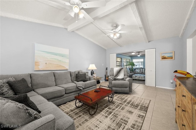 living area featuring baseboards, lofted ceiling with beams, ceiling fan, a textured ceiling, and light tile patterned flooring