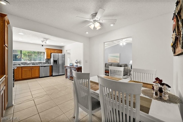 dining area with light tile patterned floors, ceiling fan, a textured ceiling, and recessed lighting