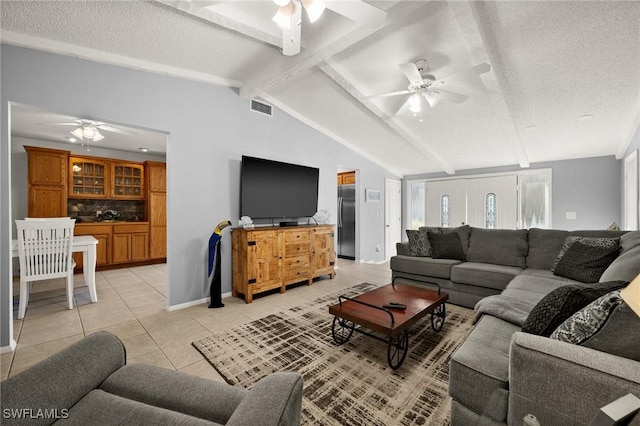 living room with light tile patterned floors, ceiling fan, lofted ceiling with beams, and visible vents