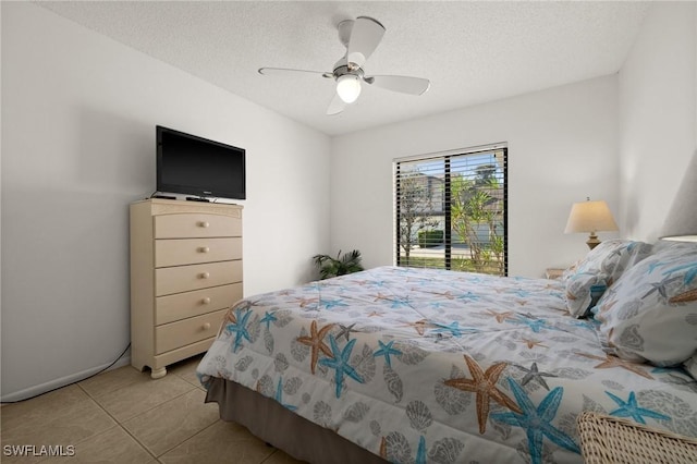 bedroom featuring ceiling fan, a textured ceiling, and light tile patterned floors