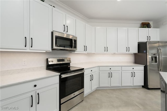 kitchen featuring white cabinets, appliances with stainless steel finishes, light countertops, and crown molding