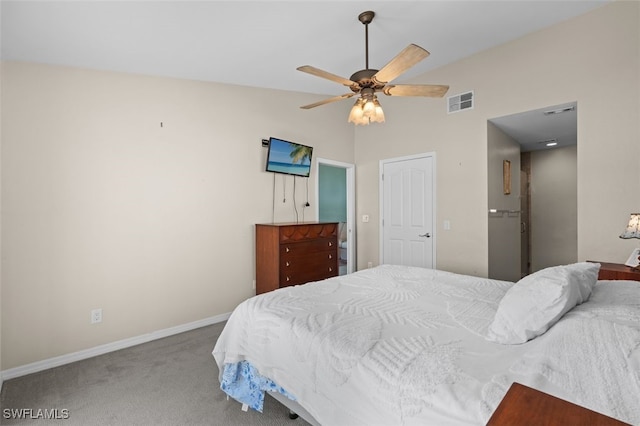 carpeted bedroom featuring a ceiling fan, visible vents, vaulted ceiling, and baseboards