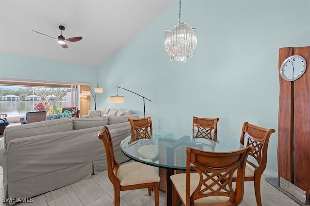 dining space with vaulted ceiling and ceiling fan with notable chandelier