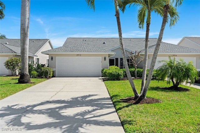 view of front of house featuring an attached garage, a shingled roof, driveway, stucco siding, and a front lawn