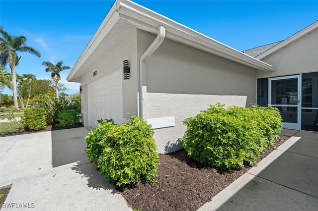 view of home's exterior featuring driveway, an attached garage, and stucco siding