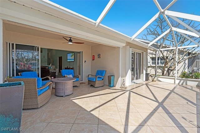 view of patio with a ceiling fan and a lanai