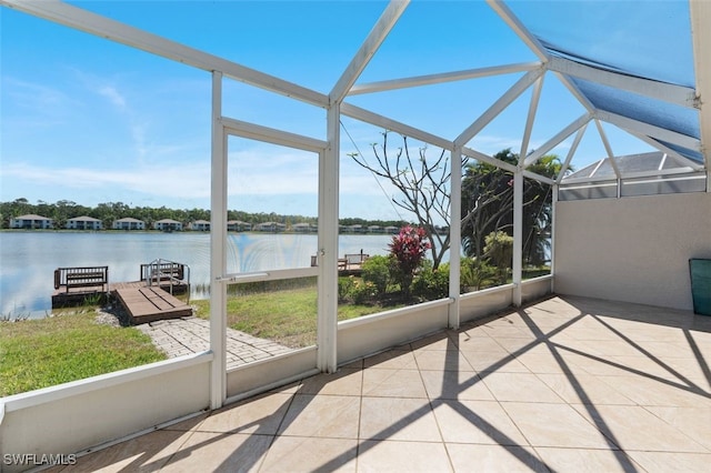 unfurnished sunroom featuring a water view