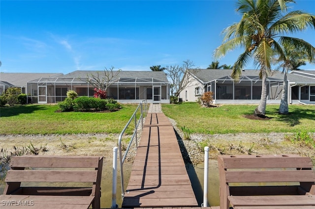 dock area featuring glass enclosure and a lawn