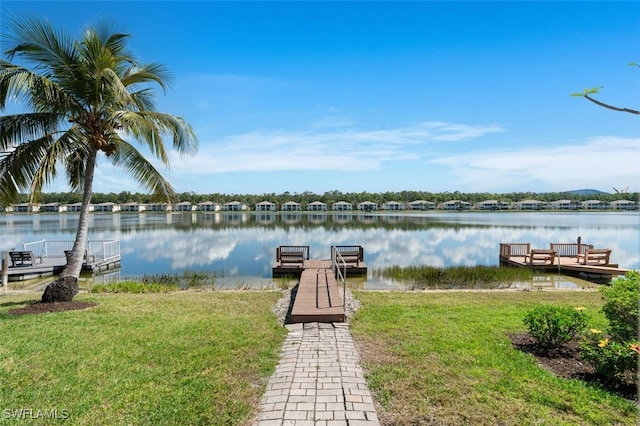 dock area featuring a lawn and a water view