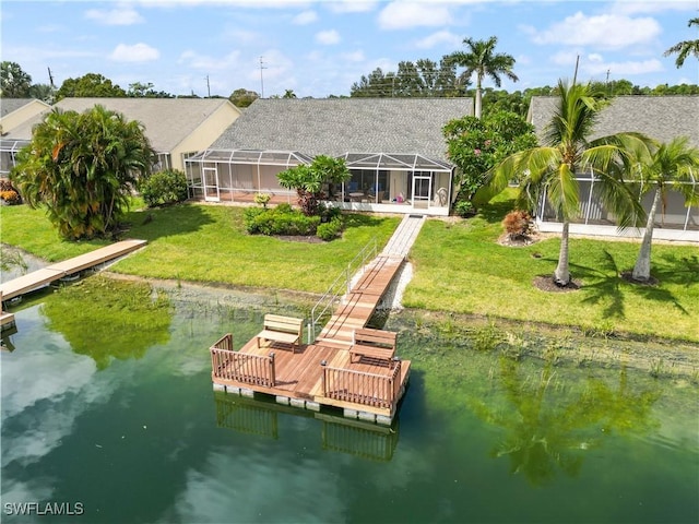 dock area with a lanai, a water view, and a yard