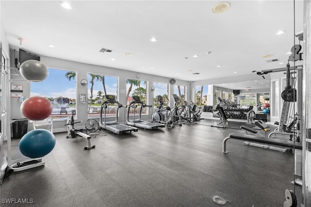 exercise room with visible vents and recessed lighting