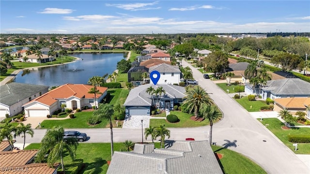 drone / aerial view with a water view and a residential view