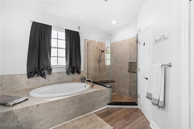 full bathroom with a garden tub, wood finished floors, and a shower stall