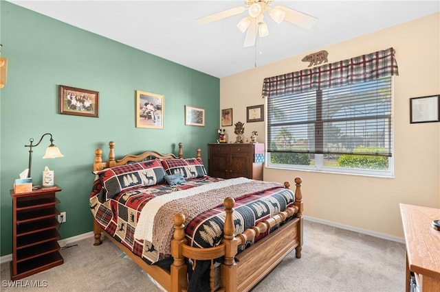 carpeted bedroom with baseboards and a ceiling fan