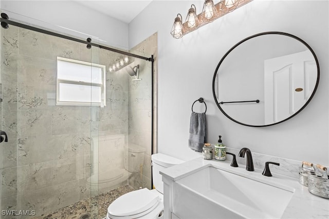 full bath featuring a stall shower, vanity, and toilet