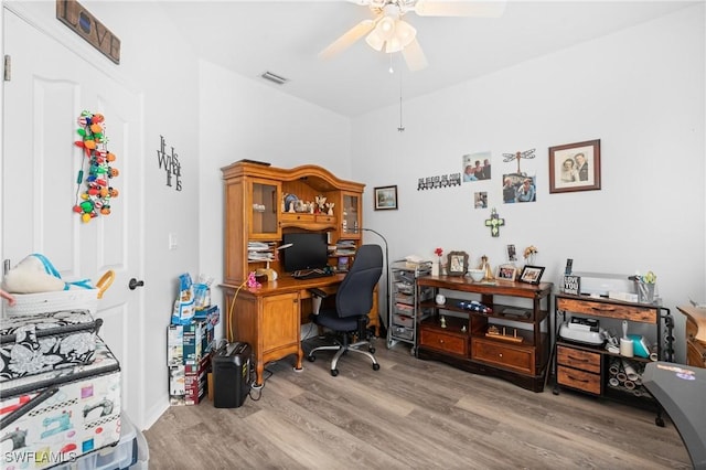 office area featuring ceiling fan, visible vents, and wood finished floors