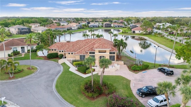 birds eye view of property with a water view and a residential view