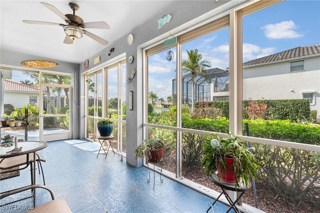 sunroom featuring ceiling fan