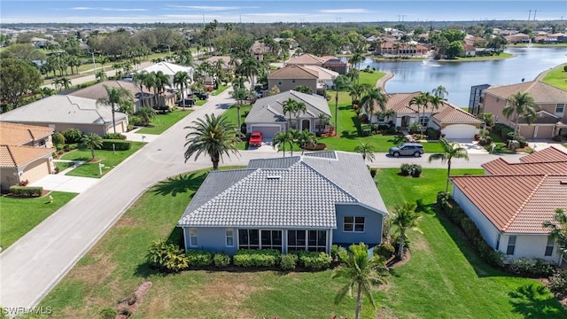 birds eye view of property featuring a water view and a residential view