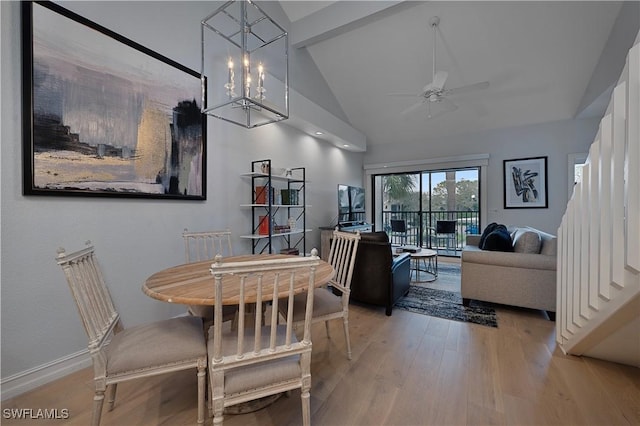 dining area with beam ceiling, wood finished floors, high vaulted ceiling, baseboards, and ceiling fan with notable chandelier