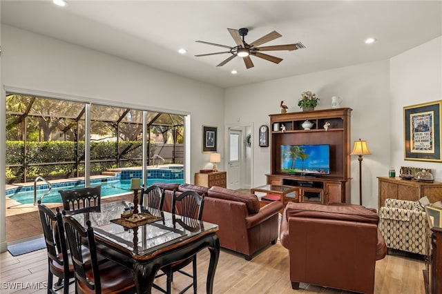 living area featuring recessed lighting, a sunroom, ceiling fan, and light wood-style flooring