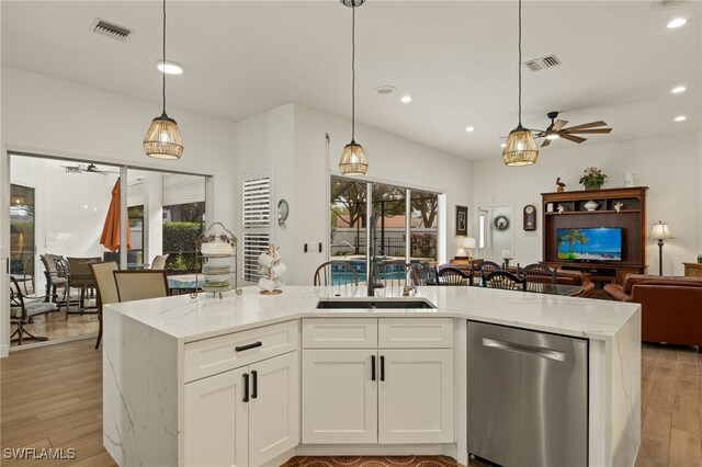 kitchen featuring light wood-style flooring, visible vents, open floor plan, and stainless steel dishwasher