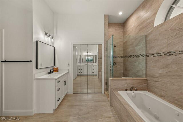 full bath featuring a shower stall, a whirlpool tub, and vanity