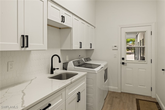 11211 Mahogany Run, Fort Myers, FL 33913 - laundry room featuring cabinet space, separate washer and dryer, and light wood-type flooring