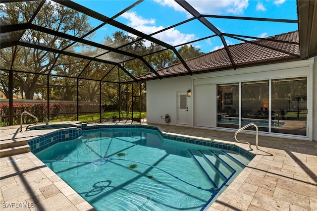 view of swimming pool featuring a patio area, a lanai, and a pool with connected hot tub