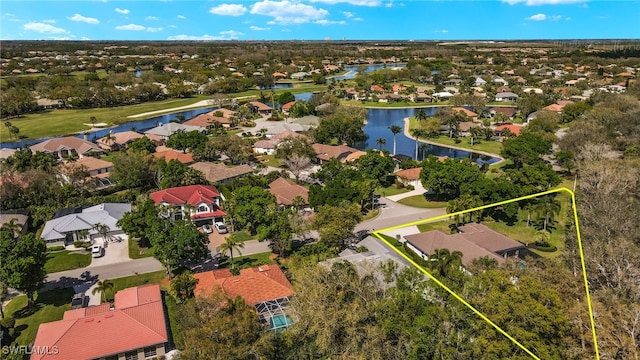 birds eye view of property featuring a water view and a residential view