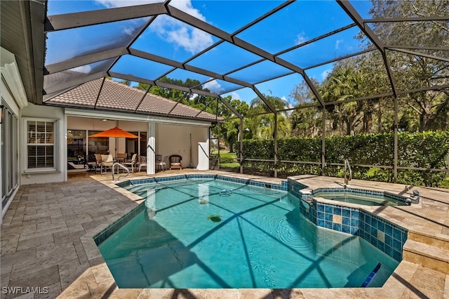 view of pool featuring glass enclosure, a pool with connected hot tub, and a patio area