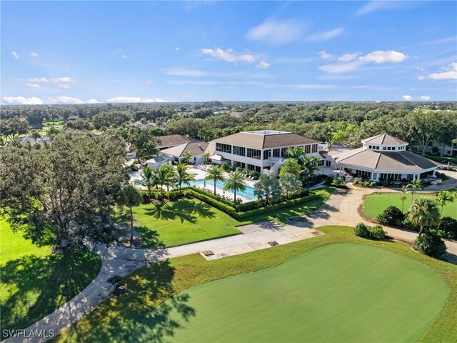 drone / aerial view featuring a wooded view