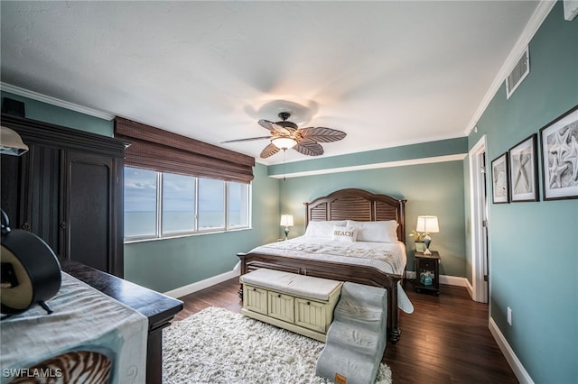 bedroom featuring baseboards, wood finished floors, and ornamental molding