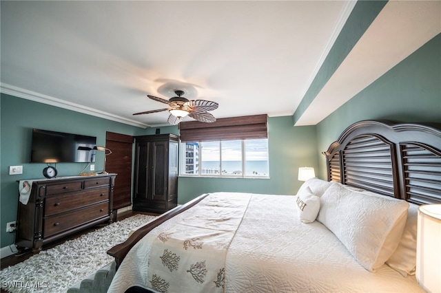 bedroom with ornamental molding, wood finished floors, a ceiling fan, and baseboards