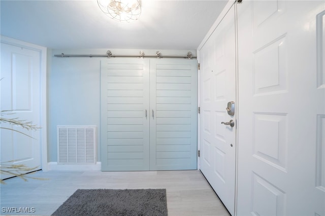 interior space with light wood-style floors and visible vents