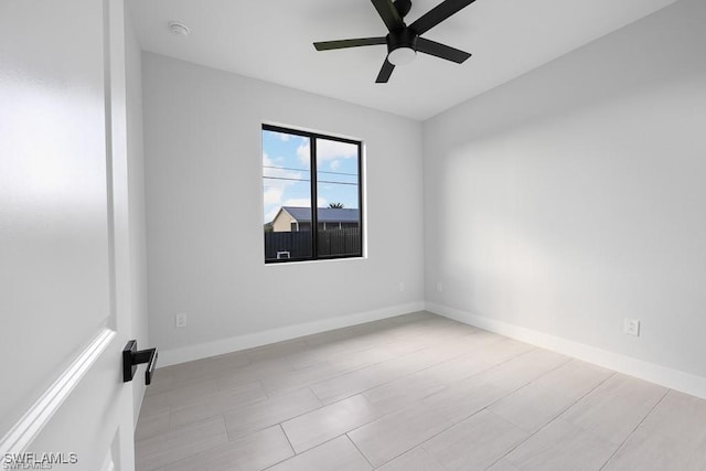 empty room with baseboards and ceiling fan