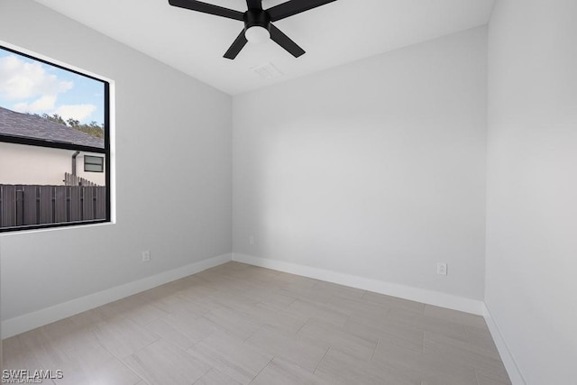 spare room featuring visible vents, baseboards, and ceiling fan