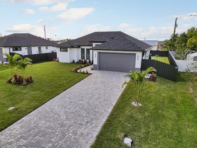 view of front of home featuring stucco siding, a front lawn, a garage, decorative driveway, and fence private yard