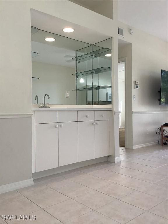 bathroom with double vanity, tile patterned flooring, a sink, and visible vents