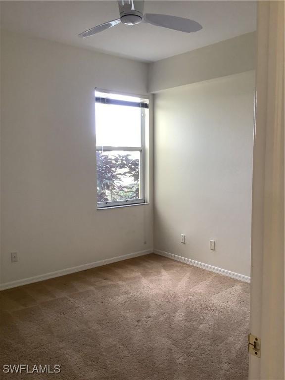 unfurnished room with carpet floors, ceiling fan, and baseboards