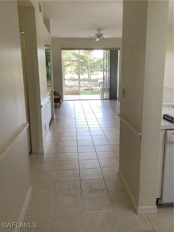 interior space featuring baseboards and light tile patterned floors