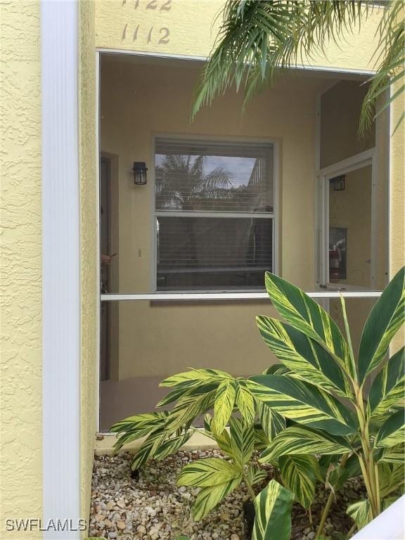 property entrance featuring stucco siding