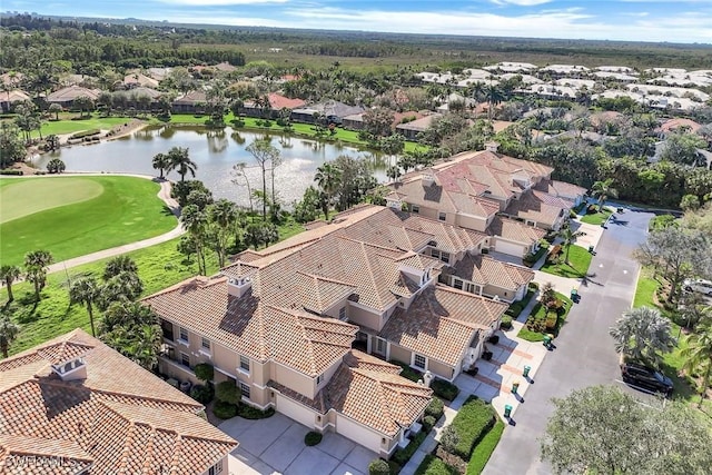 birds eye view of property with golf course view, a water view, and a residential view