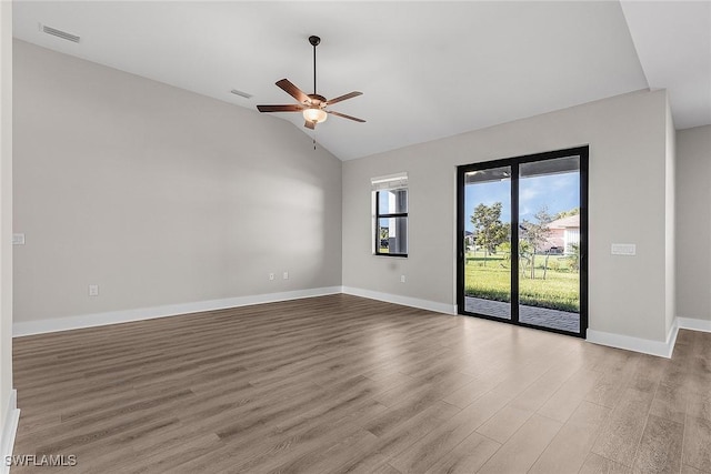 605 SW 21st Ter, Cape Coral, FL 33991 - spare room featuring wood finished floors, a ceiling fan, baseboards, and vaulted ceiling
