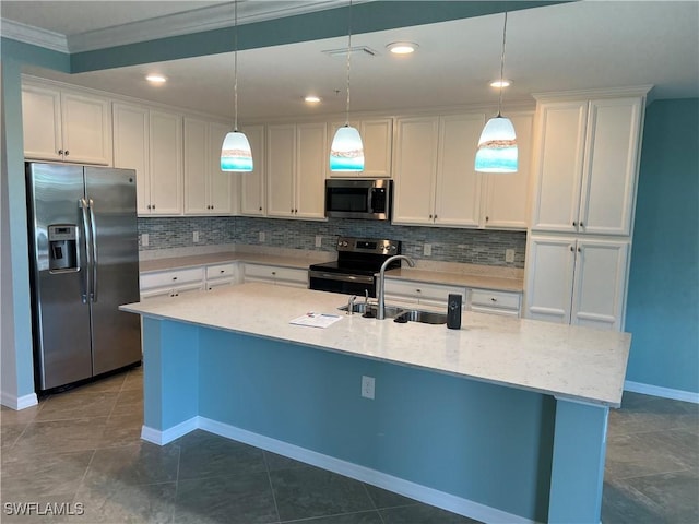 kitchen with backsplash, white cabinets, appliances with stainless steel finishes, and a sink