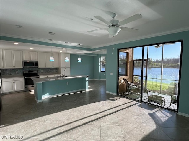 kitchen featuring backsplash, ornamental molding, appliances with stainless steel finishes, white cabinetry, and a sink