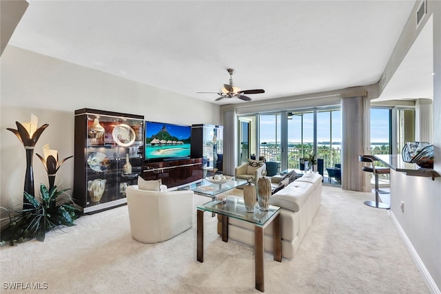 living room with ceiling fan, carpet flooring, baseboards, and visible vents